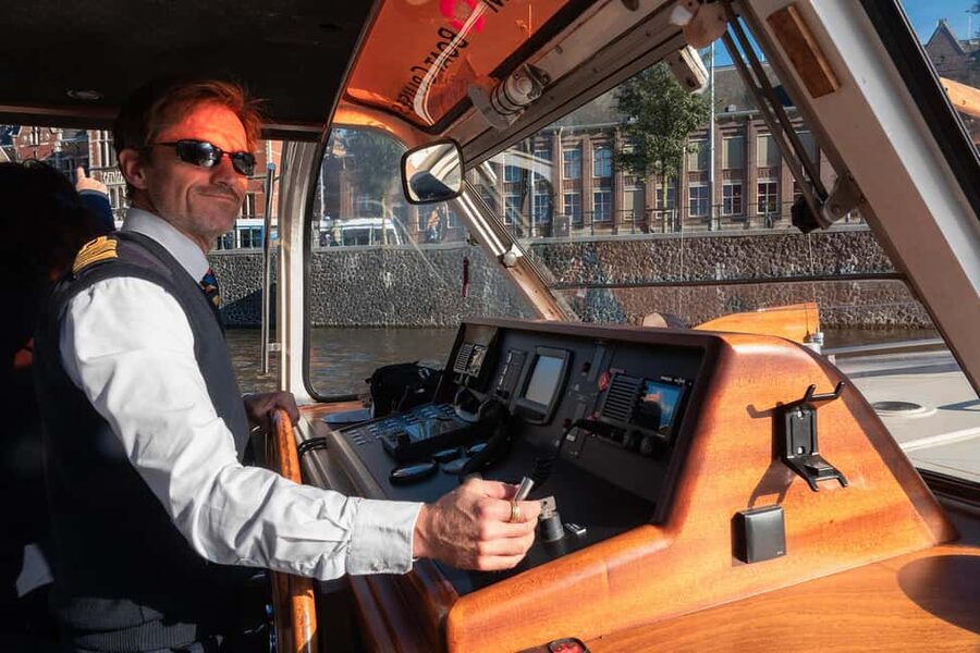 Amsterdam: Canal Cruise with Live Commentary & Audio Guide - What you actually see: bridges, churches, and that skinny wooden bridge
