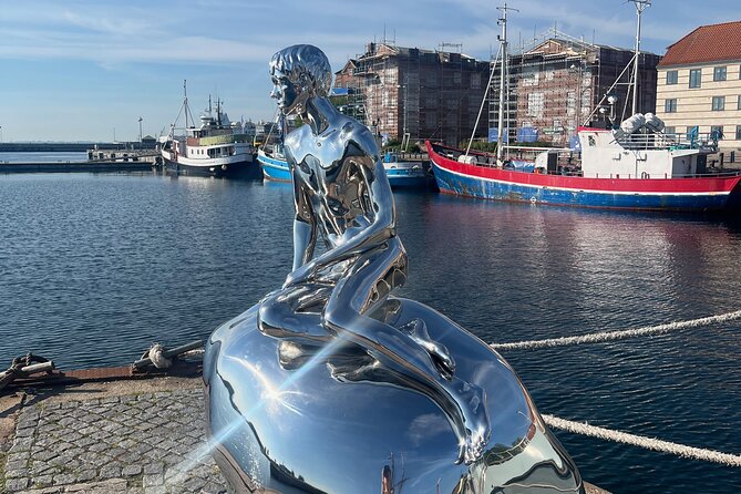 Helsingør Castle and Historic City Self-Guided Walking Tour - The He statue and a mural that explains the Middle Ages