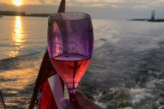 Riga: Evening or Sunset Boat Tour with Drink and Audio Guide - Sunset vs night cruise: pick your Riga mood