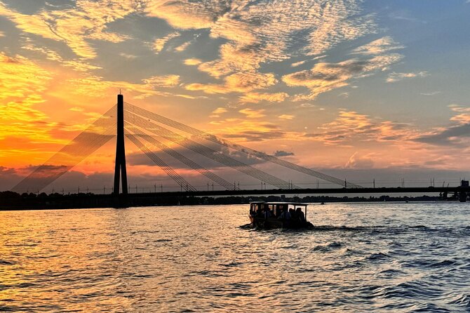 Riga: Evening or Sunset Boat Tour with Drink and Audio Guide - Photography from moving water: what to do with rainy skies
